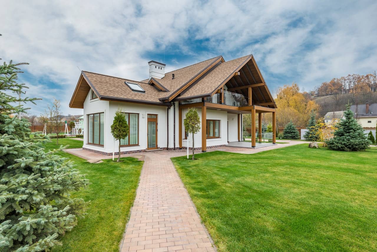 Modern home with a stone path cutting across a landscaped lawn